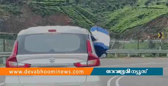 കാര്‍ ഡോറില്‍ കയറിയിരുന്ന് യാത്ര; മൂന്നാര്‍ ഗ്യാപ്പ് റോഡില്‍ വീണ്ടും അപകടയാത്ര